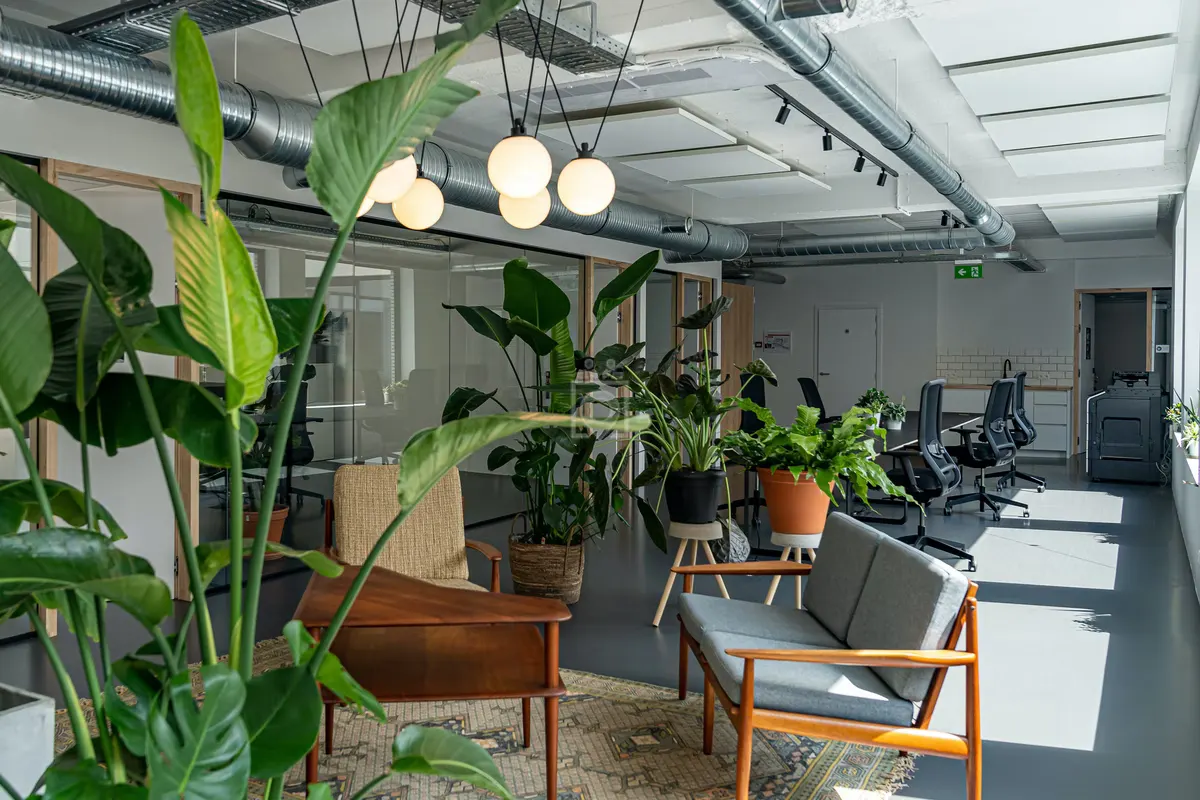 Bright open-plan office with plants and lounge chairs at Kohezie, Coupure Rechts